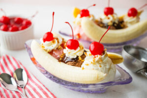How-To-Guide To Make The Perfect Banana Split Sundae image 2 banana split in glass dessert dish showing the layers Frosted Fusions
