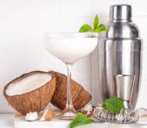 A Dairy-Free Coconut Mojito Cocktail Sorbet With Mocktail Options image 2 Mojito Sorbet in glasses with fresh mint leaves fresh coconut and cocktail shaker Frosted Fusions
