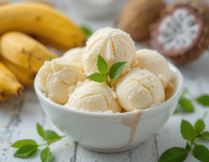 Learn-How-To-Make-Ice-Cream-Without-Added-Sugar-image-3 bowl of vanilla ice cream with fresh bananas stevia leaves and monk fruit in the background Frosted-Fusions