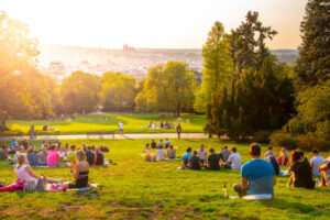 Picnic-Perfect-Ice-Cream-—-How-To-Pack-Frozen-Treats-For-Outdoor-Adventures-image-2-beautiful-sunshiny-day-with-several-people-at-a-park-picnicing-Frosted-Fusions