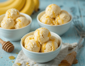 Summer-Holidays-Day-2-Mum-Im-Bored-Fun-Ice-Cream-Ideas-For-Kids-image-7-gbowls-of-banana-and-honey-ice-cream-with-fresh-bananas-and-honey-drizzlers-Frosted-Fusions